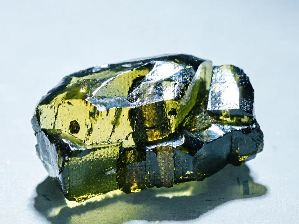 Moldavite (Czech Tektite) specimen on a neutral background.